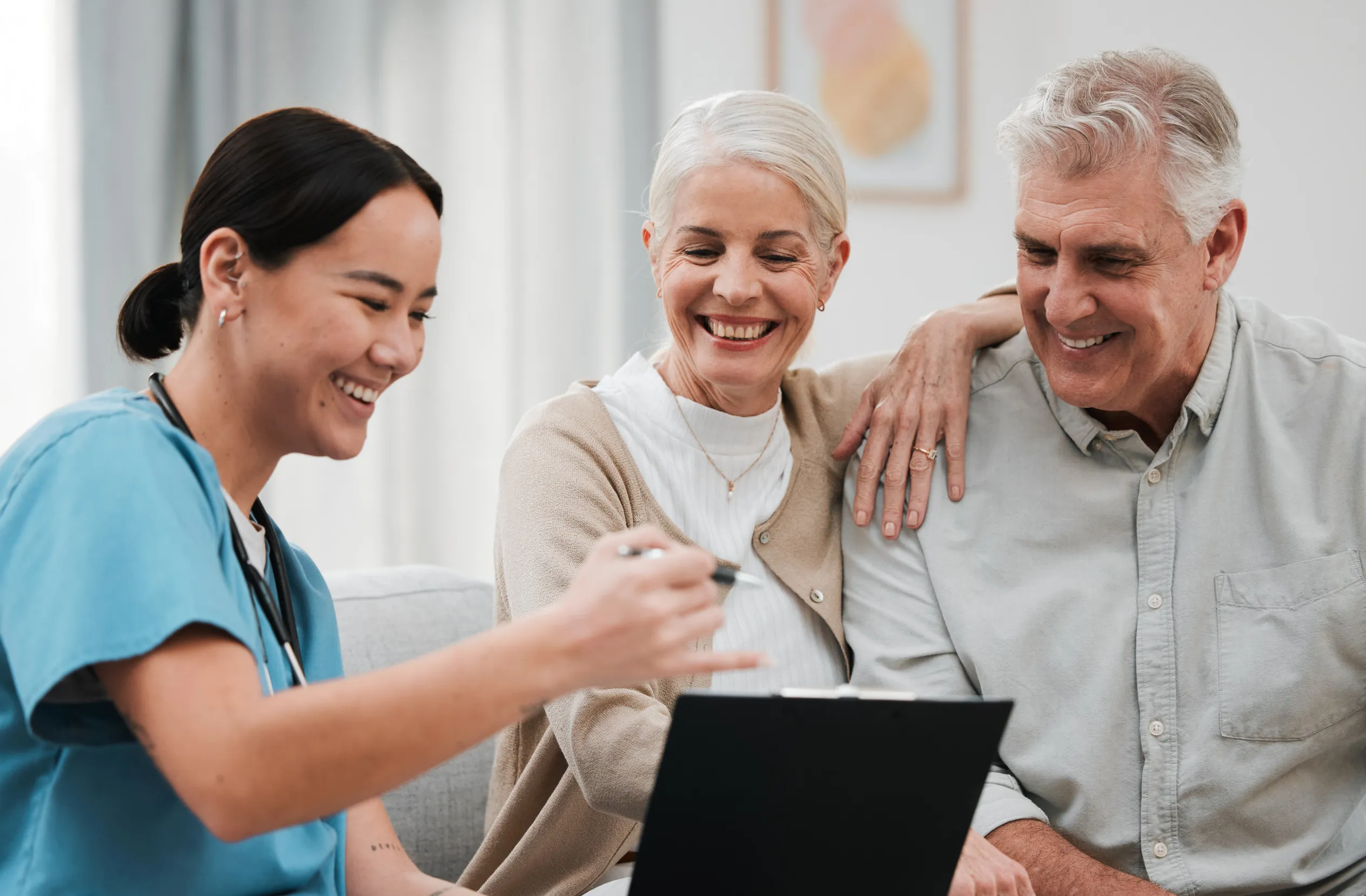 Nurse, healthcare and support with a senior couple in their home Nurse, healthcare and support with a senior couple in their home